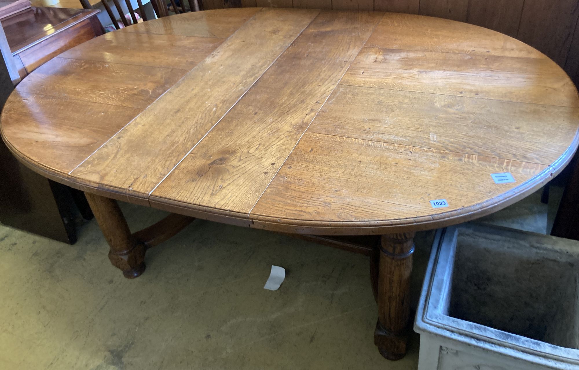 A 17th century style oak dining table, length 268cm extended (two spare leaves), width 122cm, height 74cm